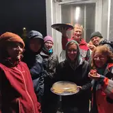 Personengruppe mit Kuchen steht und feiert